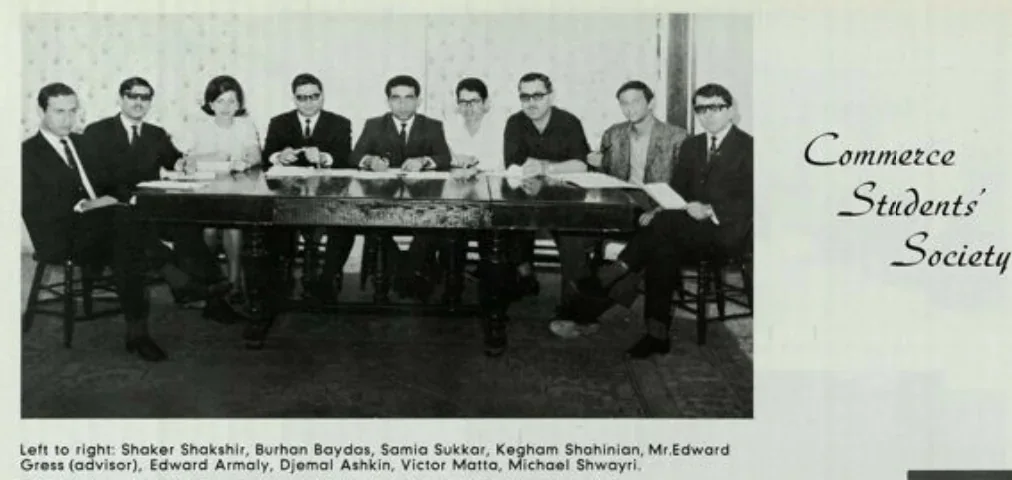 Members of the Commerce Students' Society seated around a meeting table, archive photograph in black and white
